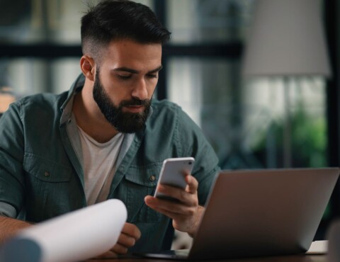 Digital-Marketing-Man-looking-through-content-on-their-phone